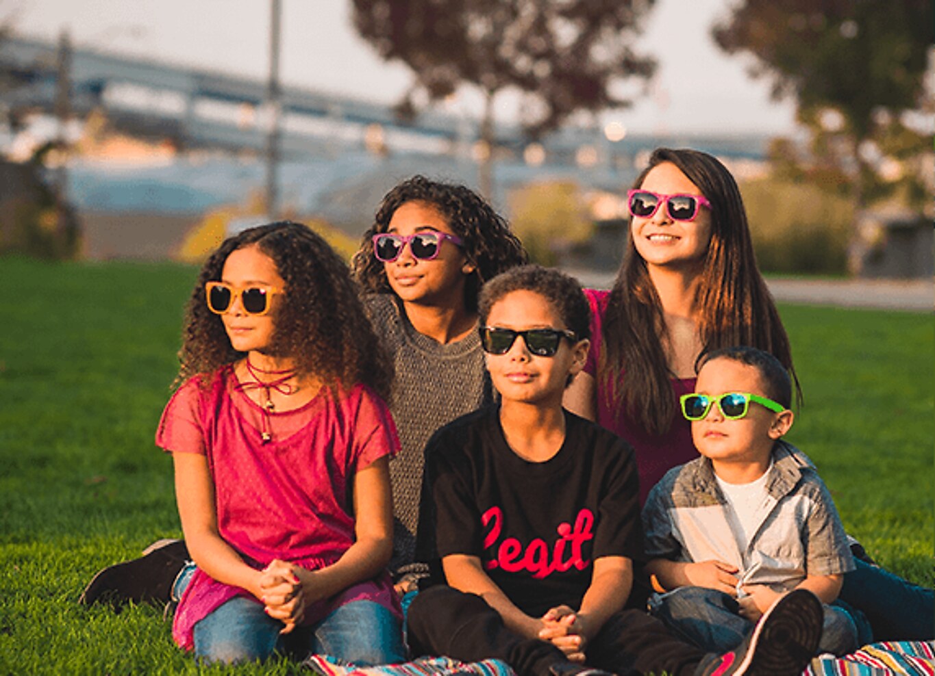 Children of different ages wearing kids' sunglasses