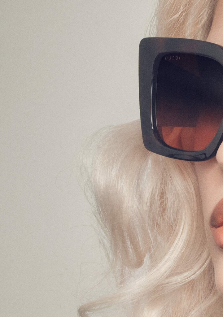 Gucci sunglasses face-focused — Italian luxury close-up
