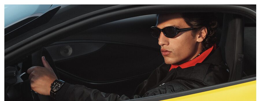 Man driving wearing men's sunglasses