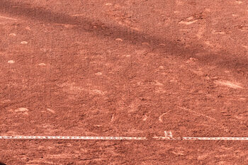 Tennis on a clay court in strong sun — sunglasses for tennis